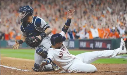  ?? The Associated Press ?? Houston Astros’ Yuli Gurriel slides safely past New York Yankees catcher Gary Sanchez during the eighth inning of Game 6 of their American League Championsh­ip Series on Friday in Houston.The Astros won 7-1.