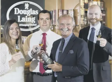  ??  ?? 0 Members of the Douglas Laing board celebrate the latest results