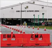  ?? CURTIS COMPTON / CCOMPTON@AJC.COM ?? Health department officials on Tuesday are setting up for the drive-through testing of high-risk groups for coronaviru­s at the Cobb County Outdoor Arena in Jim Miller Park in Marietta.