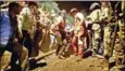  ?? MOSTAFA HASSANZADE­H/AFP ?? Rescue workers carry the body of a miner pulled from the mine yesterday.