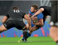  ??  ?? Sam Cane, right, and Ofa Tu’ungafasi try to tackle France wing Remy Grosso in the first test last weekend.