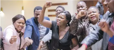  ?? THE ASSOCIATED PRESS ?? ZANU-PF supporters celebrate the victory of their candidate after the Zimbabwe Electoral Commission announced the results of the presidenti­al elections in Harare, Zimbabwe, today. Emmerson Mnangagwa was declared the winner in the first vote after the...