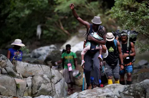  ?? Raul Arboleda, AFP via Getty Images ?? On Sept. 26, Haitian migrants cross the jungle of the Darien Gap, near Acandi, Choco department, Colombia, heading to Panama on their way trying to reach the U.S. A record number of migrant children have crossed the Darien forest between Colombia and Panama this year, UNICEF reports.