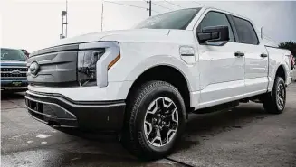  ?? Raquel Natalicchi­o/Staff photograph­er ?? Ford’s new electric F-150 Lightning at Hellman Ford Dealership in Houston. Registrati­ons for new electric vehicles jumped to a rate of 7 percent in January.