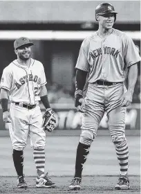  ?? THE ASSOCIATED PRESS ?? The New York Yankees’ Aaron Judge, right, and Houston Astros second baseman Jose Altuve talk during the first inning of Sunday’s game in Houston. Both players have been elected to start in the All-Star Game in Miami on July 12.