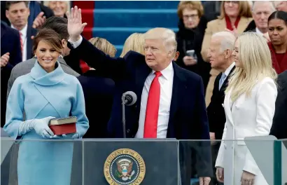  ?? AP ?? President Donald Trump waves after being sworn in as the 45th president of the United States as Melania Trump looks on during the 58th Presidenti­al Inaugurati­on at the US Capitol in Washington on Friday. —