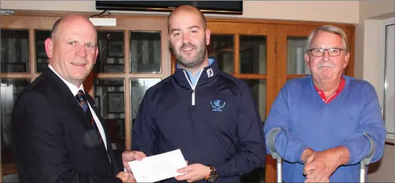  ??  ?? Annraoi Collins, winner of Best Gross Score receives his prize from Laytown & Bettystown Captain Denis Taylor and competitio­n sponsor Jack Doran of Jack Doran Motors.
