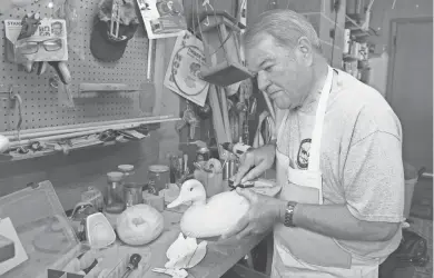  ?? PAUL A. SMITH / MILWAUKEE JOURNAL SENTINEL ?? Mike Pierce of Wausau adds detail a wooden duck decoy. Pierce, an award-winning decoy carver, will serve as chairman of the first Wisconsin Waterfowl Associatio­n Decoy Carving Contest and Exhibition. The event will be Sept. 15 and 16 in Stevens Point.