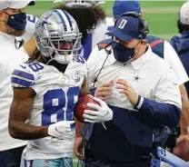  ?? Ron Jenkins / Associated Press ?? Cowboys coach Mike McCarty talks with rookie receiver CeeDee Lamb after Lamb returned an onside kick for a score.