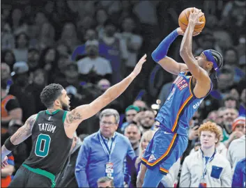  ?? Nate Billings The Associated Press ?? Oklahoma City Thunder guard Shai Gilgeous-alexander, right, shoots over Boston Celtics forward Jayson Tatum in a 127-123 victory on Tuesday.