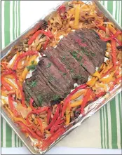  ?? PHOTO BY CATHY THOMAS ?? Fajita Flank Steak with Peppers and Onions is tasty stuffed between warm tortillas.