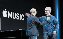  ?? JEFF CHIU/AP ?? Apple CEO Tim Cook, right, greets record producer Jimmy Iovine at the Apple Music launch event in San Francisco in early June.