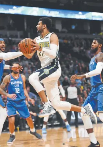  ?? John Leyba, The Denver Post ?? Nuggets guard Jamal Murray flies through the lane as Oklahoma City forward Carmelo Anthony, left, tries to stop him in a preseason game Tuesday.