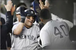  ?? NICK WASS — THE ASSOCIATED PRESS ?? >>
The Yankees' Jose Trevino, left, celebrates his three-run home run with teammate Luis Severino and others in the dugout during the fourth inning against the Orioles on Monday.