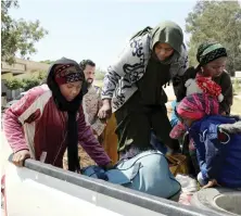  ?? An African family is being evacuated at Al-Swani area in Tripoli, Libya. ??