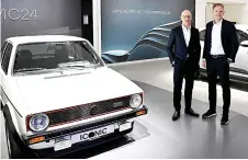  ?? — AFP photo ?? Blume (right) and the company’s CFO Arno Antlitz pose next a Golf 1 GTI after a press conference to present the company’s results, in Berlin.