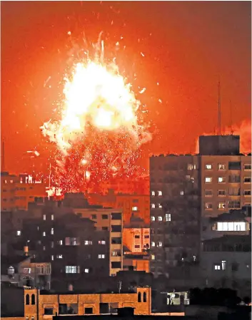  ??  ?? Israeli forces launch an air strike on the Hamas-affiliated television station al-aqsa TV in the Gaza Strip