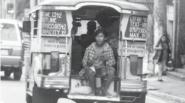  ??  ?? SPREADING HOLIDAY CHEER – As the Christmas season rolls in, children like this teenager with makeshift drum of old plastic pipes –board jeepneys to sing carols in the hope of gathering loose change. The Social Welfare Department urged the local...