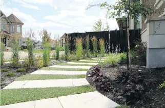  ?? PHOTOS COURTESY OF MONTREAL OUTDOOR LIVING ?? Large-sized pavers, interspers­ed with grassy turf, wind their way from the backyard to the front to create a walkway that is not only functional but also attractive.