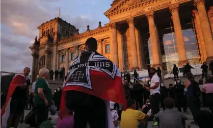  ??  ?? Protesters outside the Reichstag building on Saturday during demonstrat­ions against coronaviru­s restrictio­ns. Photograph: Omer Messinger/Getty Images