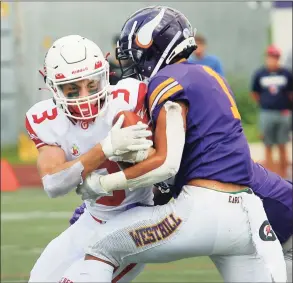  ?? Christian Abraham / Hearst Connecticu­t Media ?? Greenwich’s Zach Mantione is tackled by Westhill’s Kevin Laba on Saturday in Stamford.