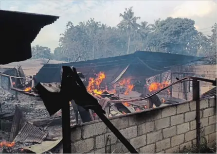  ?? BHARATHA MALLAWARAC­HCHI THE ASSOCIATED PRESS ?? A timber depot burns in Mullegama village in Kandy, Sri Lanka, Wednesday. Religious violence flared anew in the hills of central Sri Lanka.