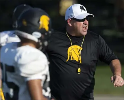  ?? MATHEW MCCARTHY, RECORD STAFF ?? University of Waterloo football head coach Chris Bertoia tells his players to up the tempo during a practice at Warrior Field on Thursday.