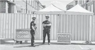  ?? — Gambar AFP ?? MASIH BERISIKO TINGGI: Dua pegawai polis berkawal dekat kawasan larangan di Rollestone Street, pinggir John Baker House di Salisbury, selatan England kelmarin.