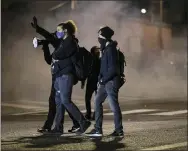  ?? PAULA BRONSTEIN,FILE - THE ASSOCIATED PRESS ?? In this Sept. 5, 2020file photo, protesters take to the streets Friday, Sept. 5, 2020, in Portland, Ore. Amid protests following the police killing of George Floyd last year Portland dissolved a special police unit designed to focus on gun violence.