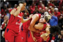  ?? ALEX BRANDON — THE ASSOCIATED PRESS ?? Washington Mystics guard Natasha Cloud, left, forward Elena Delle Donne and guard Kristi Toliver celebrate during the second half of Game 5of basketball’s WNBA Finals, Thursday in Washington.