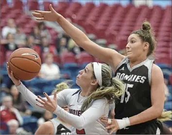  ?? Peter Diana/Post-Gazette ?? Duquesne’s Chassidy Omogrosso drives past St. Bonaventur­e’s Emily Calabrese Saturday at Palumbo Center. Omogrosso scored 26 points to lead the Dukes to an 80-64 win.