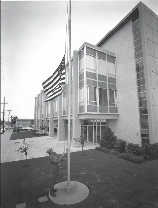  ?? TIMES-STANDARD FILE PHOTOS ?? Eureka City Hall custodian lowered the flag outside the building following news of the death of President John F. Kennedy on Nov. 22, 1963.