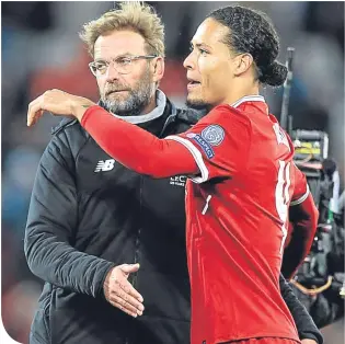  ??  ?? Virgil van Dijk and Jurgen Klopp embrace at time-up at Anfield last Wednesday