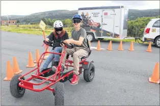  ?? SAM MCNEISH/THE TELEGRAM ?? Students, staff and some visitors to Waterford Valley High School on Monday found out how difficult it is to operate any motorized vehicle while impaired. Shelby King, Grade 10, and Toby May, Grade 11, try to negotiate the peddle cart that was on hand...