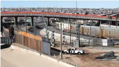  ?? Eric Gay/Associated Press ?? ■ A new barrier is being built Jan. 22 along the Texas-Mexico border near downtown El Paso. Such barriers have been a part of El Paso for decades and are being expanded, even as the fight continues over President Donald Trump’s desire to wall off the entire U.S.-Mexico border.