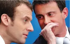  ??  ?? Former French Prime Minister Manuel Valls (right) speaks with president-elect’s Emmanuel Macron in Paris. — AP