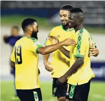  ?? MAKYN/MULTIMEDIA PHOTO EDITOR RICARDO ?? Jamaica players Adrian Mariappa (left) and Michael Hector celebrate with goalscorer Cory Burke (right) during the Jamaica vs Cayman Islands Concacaf Nations League match at the National Stadium on Sunday night.