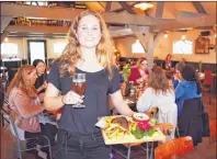  ?? STEVE MACNAULL ?? Julia Robeer serves up Dutch comfort food with a Sour Pale Ale from local brewery Poly Amorie at De Vergulden Eenhoorn restaurant, which is in a retrofitte­d circa 1702 former dairy barn.