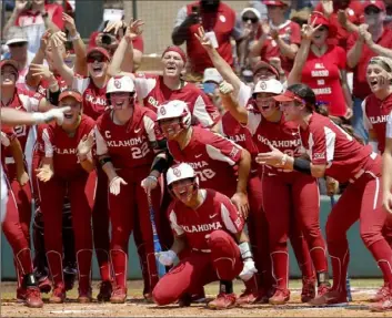  ?? Associated Press ?? FEELING GOOD, LOOKING GOOD Oklahoma players celebrate a home run from Grace Lyons Saturday in a 7-1 NCAA superregio­nal victory against Central Florida in Norman, Okla. The win advances the Sooners to the College World Series.