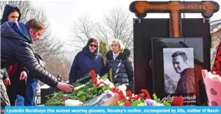  ?? ?? Lyudmila Navalnaya (the woman wearing glasses), Navalny’s mother, accompanie­d by Alla, mother of Navalny’s widow Yulia, visits the grave of her son on March 2, 2024, the next day after his funeral.