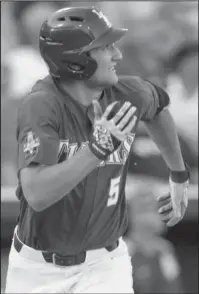  ?? The Associated Press ?? GOING, GOING, GONE: LSU’s Jake Slaughter watches his threerun home run during the second inning of the Tigers’ 7-4 win over Florida State in an eliminatio­n game of the College World Series Wednesday night in Omaha, Neb.