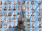  ?? SERGEI SUPINSKY/AFP VIA GETTY IMAGES ?? A woman touches a picture of her deceased son at the Memory Wall of Fallen defenders of Ukraine in Kyiv, Ukraine.