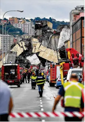  ?? PAOLO RATTINI / GETTY IMAGES ?? A 260-foot section of the span collapsed atop an industrial area of warehouses. A man who was standing under the bridge in front of his truck at the time of the collapse called it “a miracle” that he survived.
