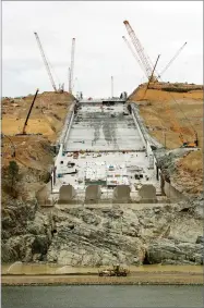  ?? AP PHOTO BY RICH PEDRONCELL­I ?? This Oct. 19, 2017 file photo shows repair work on the damaged main spillway of the Oroville Dam in Oroville. One year after the closest thing to disaster at a major U.S. dam in a generation, federal dam regulators say they are looking hard at how they...