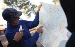  ??  ?? Be sure to know where you’re going. Here, outback expert and former geologist Nick Crase checks on his route.