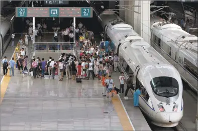  ?? Andy Wong / AP file photo ?? Passengers disembark a CRH high-speed train at the South Train Station in Beijing, China on July 26, 2011.