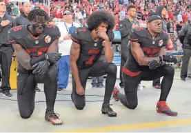  ?? KIRBY LEE/USA TODAY SPORTS ?? The 49ers’ Eli Harold (58), Colin Kaepernick (7) and Eric Reid (35) knelt in protest during the national anthem Oct. 6, 2016.