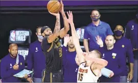  ?? Mark J. Terrill Associated Press ?? AFTER ANTHONY DAVIS hit this winning shot in the playoffs last season against Denver, James said he wished it could have happened at Staples Center.