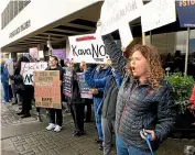  ?? AP ?? Molly Knight, right, takes part in a demonstrat­ion objecting to the nomination of Brett Kavanaugh for U.S. Supreme Court justice rally outside the office of Senator Lisa Murkowski, R-Alaska.