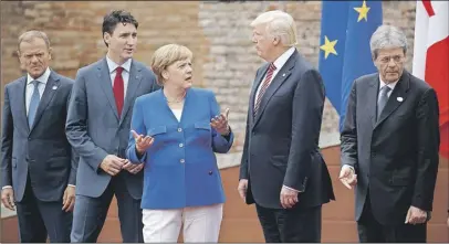  ?? AP PHoto ?? G7 leaders (from left) EU President Jean-Claude Junker, Canadian Prime Minister Justin Trudeau, German Chancellor Angela Merkel, President Donald Trump, and Italian Prime Minister Paolo Gentiloni, pose for a family photo at the Ancient Greek Theatre of...